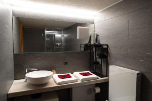 a bathroom with a sink and a mirror at MANY'S historical city central APARTMENTS in Zurich