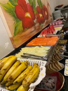 a buffet with bananas and carrots and other foods at HOTEL PLAZA PONTES e LACERDA in Pontes e Lacerda +62 photos