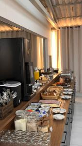 a buffet line with food on it in a kitchen at GoldMen Express Campos Goytacazes in Campos dos Goytacazes