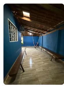 a room with a bench and a blue wall at Casa da Vila de São Jorge in Sao Jorge