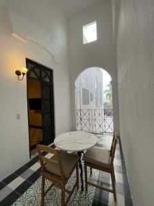 a dining room with a table and two chairs at Apartamento 25 Centrico Chapala in Chapala