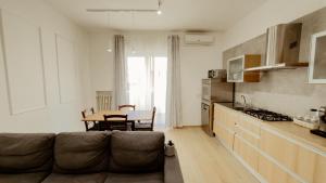 a living room with a couch and a table at Bridge's House - a 50 mt dalla spiaggia e da tutti i servizi! in Pescara