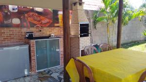 a table with a yellow table cloth on a patio at Chalé a beira mar ilhéus in Ilhéus +4 photos