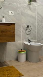 a bathroom with a sink and a toilet at Lumèra Holiday Home in Pizzo