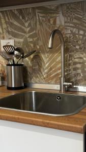 a kitchen sink with a faucet on a counter at Lumèra Holiday Home in Pizzo