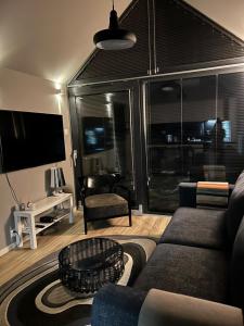 a living room with a couch and a tv at Happy Jura in Biskupice
