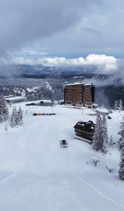 a building on top of a snow covered mountain at Prestige Lux Andan - Apart hotel Horizont Jahorina in Jahorina