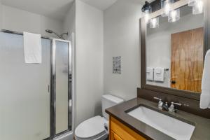 a bathroom with a sink and a shower and a toilet at 4 Jay Lane in Sunriver +97 photos