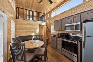 a kitchen with a table and chairs and a refrigerator at Arches Hut in Moab