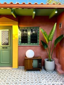 a house with a tv and a plant in front of it at Santa Clara - the revolution of living in Chalkida