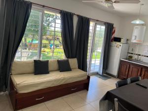 a living room with a couch in front of a window at El VIEJI in Colón