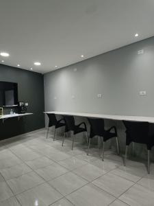 a conference room with a white table and chairs at Hotel Connect Ibira Servidor Park in São Paulo