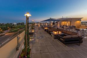 a rooftop patio with couches and tables on a building at Grand Legacy At The Park in Anaheim