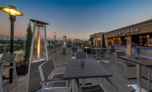 a restaurant with tables and chairs on a patio at Grand Legacy At The Park in Anaheim