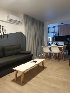 a living room with a couch and a table at ANDÉN by FMA Coliving in Salta