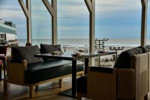 a dining room with a table and a view of the beach at Nobu Hotel Atlantic City - A Caesars Rewards Destination in Atlantic City