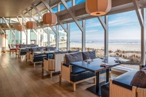 a restaurant with tables and chairs and the beach at Nobu Hotel Atlantic City - A Caesars Rewards Destination in Atlantic City