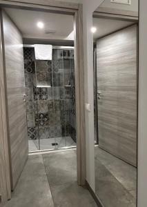 a bathroom with a shower and a glass door at La casa di Sesè in Viagrande +50 photos