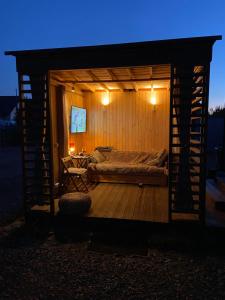 a bedroom with a bed on a wooden deck at night at Happy Jura in Biskupice +64 photos