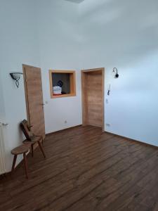 an empty room with a chair and a window at Haus Nadegger in Werfen