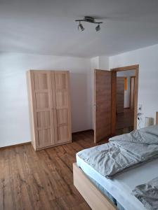 a bedroom with a bed and a closet at Haus Nadegger in Werfen