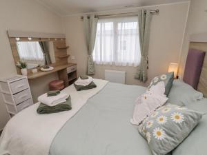 a bedroom with two beds with towels on them at Homeslea 33 Millennium Gardens in Morpeth