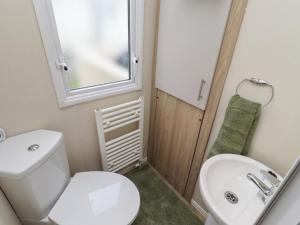 a bathroom with a white toilet and a sink at Homeslea 33 Millennium Gardens in Morpeth +11 photos