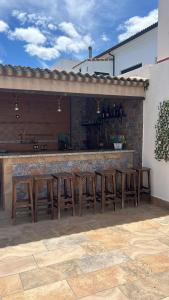 a group of tables and chairs in front of a bar at Apartamentos luz de Doñana 1 in Moguer