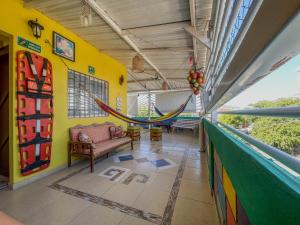 a room with a hammock on a balcony at Hostal Kumbaya in Santa Marta