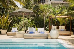 a swimming pool with lounge chairs and an umbrella at Azure Horizon Suite in Balcheil +86 photos