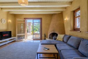 a living room with a blue couch and a fireplace at Petrino pool house in Athens