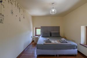 a bedroom with a bed with towels on it at Petrino pool house in Athens +36 photos