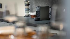 a counter top with a coffee maker on it at ESTENSIA Room & Suite in Ferrara