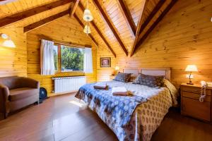 a bedroom with a bed in a wooden cabin at Bosque Dormido Cabañas & Spa in San Carlos de Bariloche +47 photos