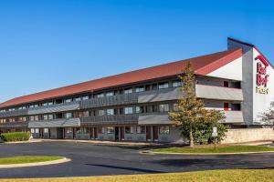 an empty parking lot in front of a building at Red Roof Inn PLUS Chicago - Hoffman Estates in Hoffman Estates