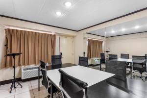 a conference room with a table and chairs and a camera at Red Roof Inn PLUS Chicago - Hoffman Estates in Hoffman Estates