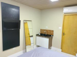 a small kitchen with a sink and a counter at EL Shaday in Guarujá