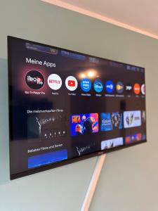 a flat screen tv hanging on a wall at Studio Apartment 1- Komfort & Günstig in Berlin
