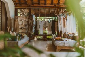 a living room filled with furniture and a large window at Coral Breeze Retreat in Balcheil