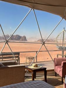 a room with a view of the desert from a tent at Star Gate Camp in Wadi Rum