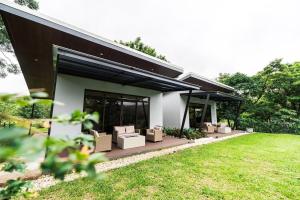 a house with a bunch of boxes on a patio at La Danta Lodge - Rio Celeste in Bijagua