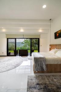 a bedroom with a large bed and a living room at La Danta Lodge - Rio Celeste in Bijagua