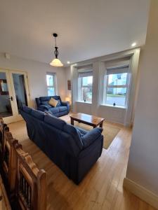 a living room with a couch and a table at Doolin Court in Doolin