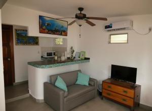 a living room with a couch and a counter at Casa del Sol Bed and Breakfast in Contadora