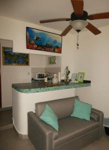 a living room with a couch and a counter at Casa del Sol Bed and Breakfast in Contadora