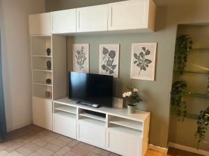 a white entertainment center with a flat screen tv at Navigli Darsena - Luxury Apartment with balcony in Milan