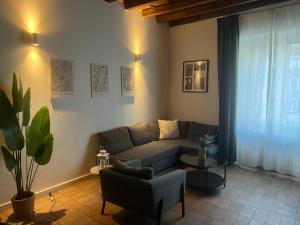 a living room with a couch and a table at Navigli Darsena - Luxury Apartment with balcony in Milan