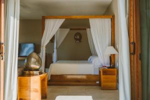 a bedroom with a bed with a canopy at Sunset Crown Suite in Balcheil