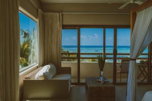 a living room with a view of the ocean at Sunset Crown Suite in Balcheil