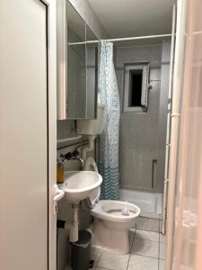 a small bathroom with a sink and a toilet at Italian Guesthouse in Baden +4 photos